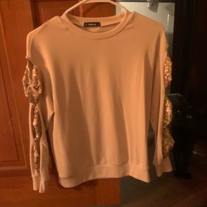 Cream sweater with slits on the sleeves- makes sparkly bows